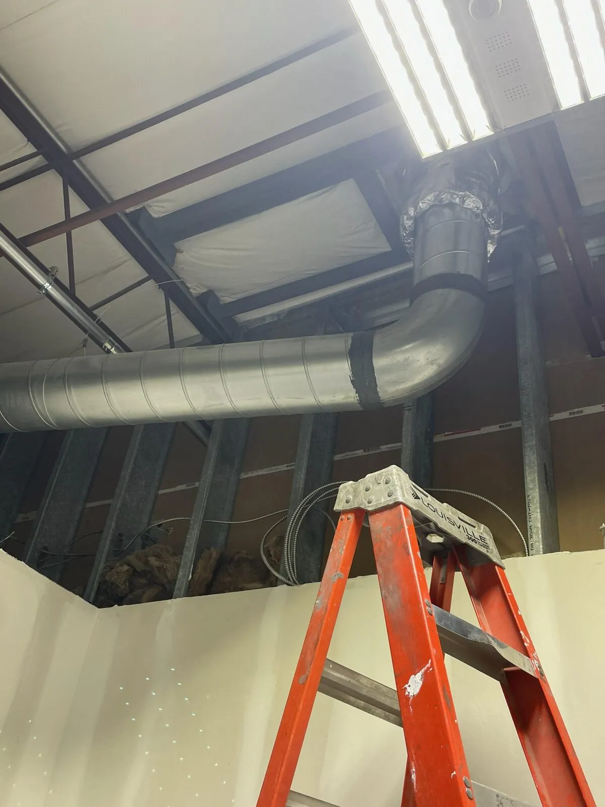 Spiral round HVAC ductwork insulated and routed at facility ceiling