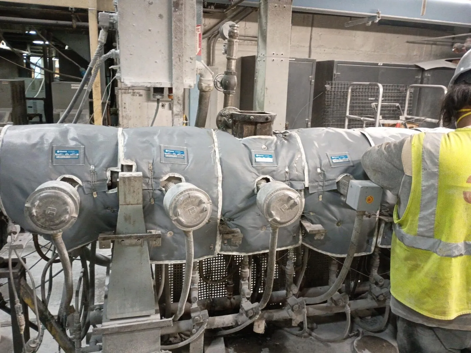 Removable insulation blankets installed on industrial machinery in active plant