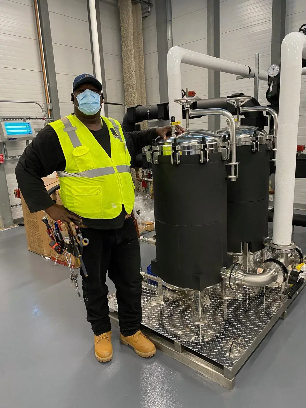 Julius Mechanical insulator on site beside newly installed filter skid