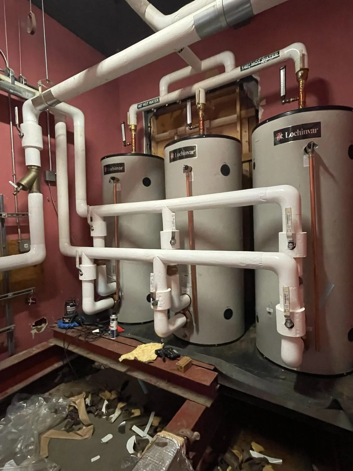 Insulated copper and steel piping serving Lochinvar hot water tanks